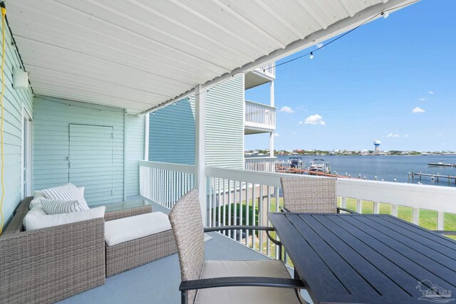 balcony featuring a water view and outdoor lounge area