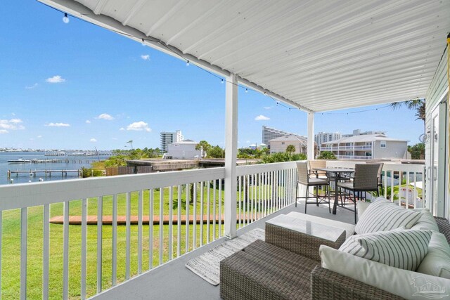 balcony with an outdoor hangout area and a water view