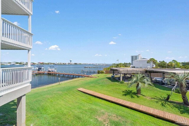 view of yard featuring a dock and a water view