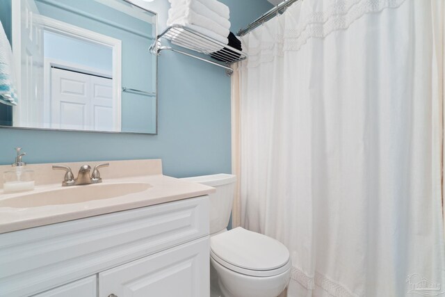 bathroom with vanity, toilet, and a shower with shower curtain