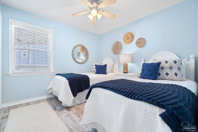 bedroom with ceiling fan and light hardwood / wood-style flooring