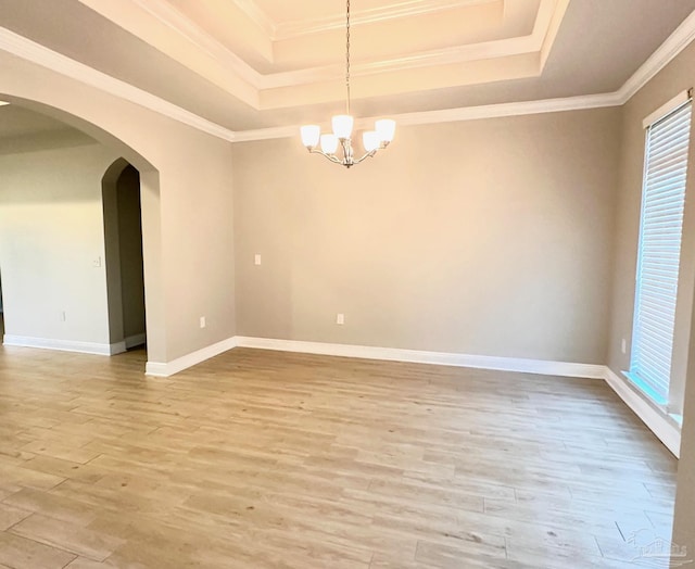 2665 Tulip Hill Rd, Pace, FL 32571 - spare room featuring a tray ceiling, arched walkways, light wood-style floors, a chandelier, and ornamental molding