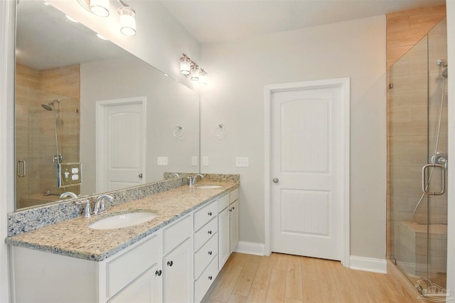 2665 Tulip Hill Rd, Pace, FL 32571 - full bath with double vanity, wood finished floors, a stall shower, and baseboards