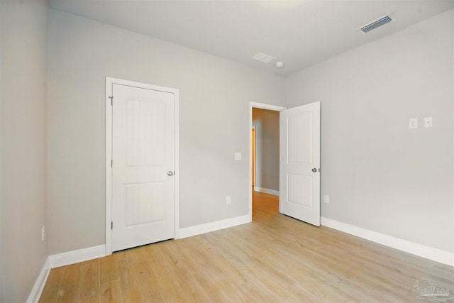 2665 Tulip Hill Rd, Pace, FL 32571 - unfurnished bedroom featuring light wood-style flooring and baseboards
