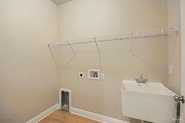 2665 Tulip Hill Rd, Pace, FL 32571 - washroom with light wood-style flooring, baseboards, hookup for an electric dryer, and washer hookup