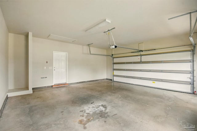2665 Tulip Hill Rd, Pace, FL 32571 - garage featuring a garage door opener and baseboards