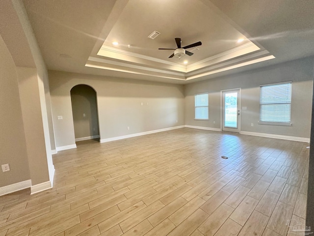 2665 Tulip Hill Rd, Pace, FL 32571 - unfurnished room with a raised ceiling, a ceiling fan, arched walkways, wood finished floors, and ornamental molding