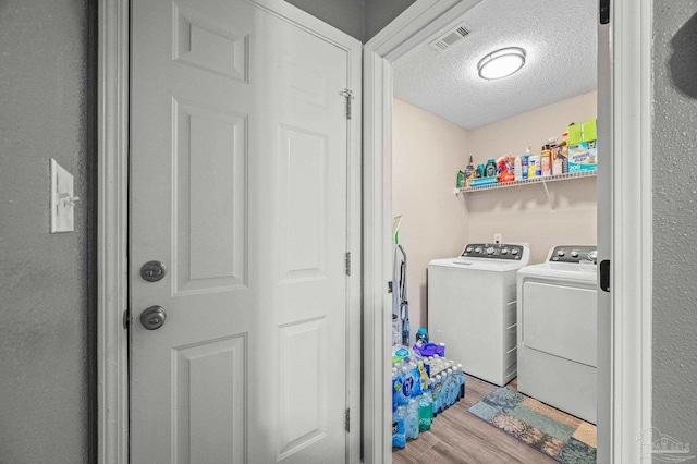 6856 Old W Ln, Milton, FL 32570 - washroom featuring wood finished floors, separate washer and dryer, and a textured ceiling