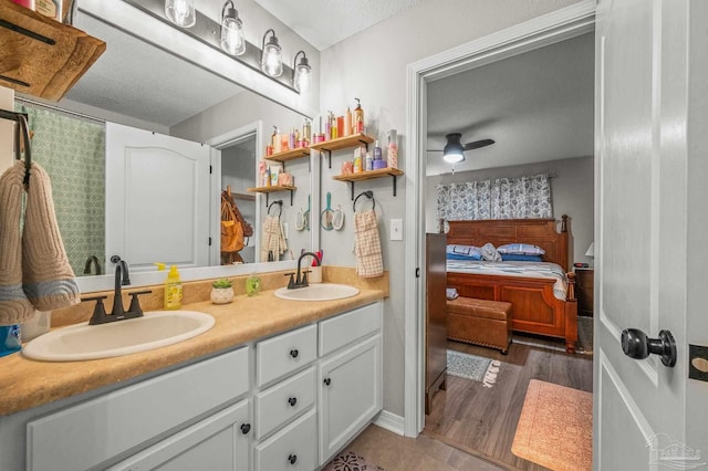 6856 Old W Ln, Milton, FL 32570 - ensuite bathroom with double vanity and a textured ceiling