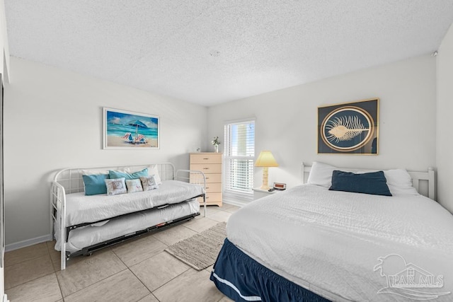 bedroom with tile patterned flooring and a textured ceiling
