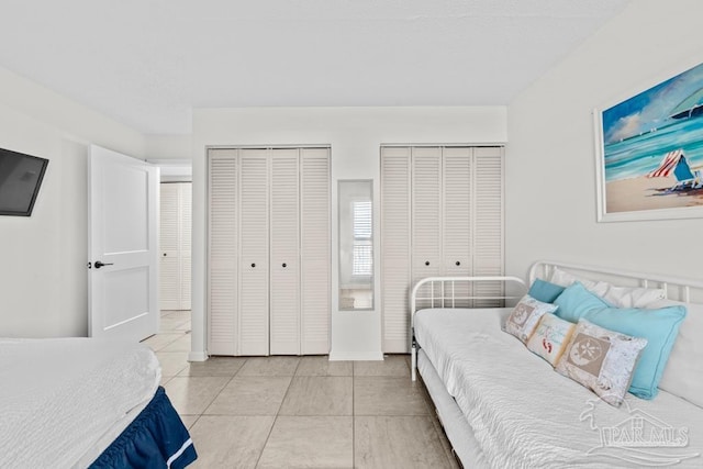 tiled bedroom with multiple closets