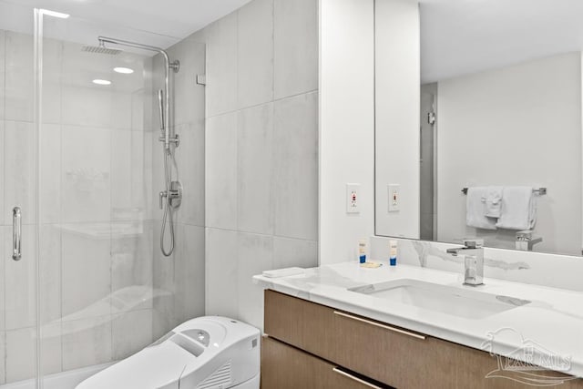 bathroom featuring vanity and a shower with door