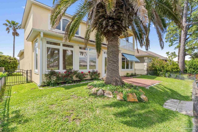 1124 Willowood Cir, Gulf Breeze, FL 32563 - exterior space featuring a yard, stucco siding, fence, and a gate