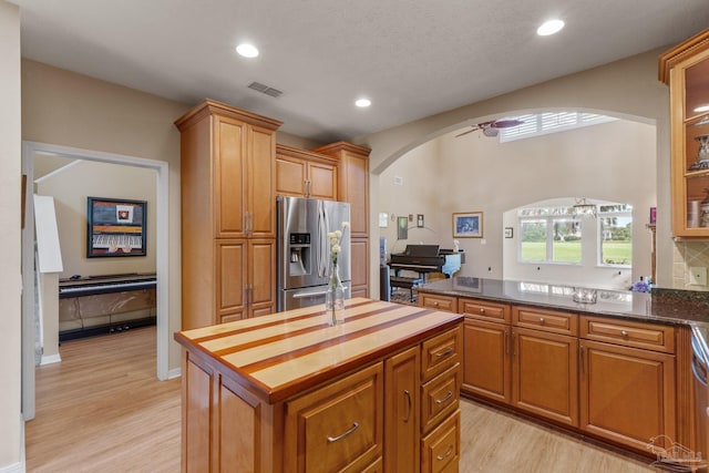 1124 Willowood Cir, Gulf Breeze, FL 32563 - kitchen with stainless steel fridge with ice dispenser, visible vents, arched walkways, light wood-style floors, and recessed lighting