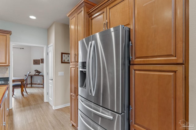 1124 Willowood Cir, Gulf Breeze, FL 32563 - kitchen with light wood-type flooring, baseboards, stainless steel fridge, recessed lighting, and brown cabinets