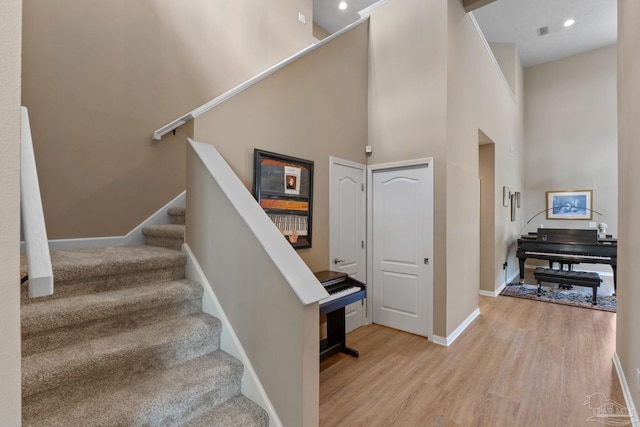 1124 Willowood Cir, Gulf Breeze, FL 32563 - stairway featuring a towering ceiling, baseboards, recessed lighting, visible vents, and wood finished floors