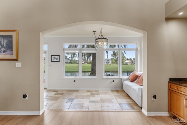 1124 Willowood Cir, Gulf Breeze, FL 32563 - foyer entrance featuring a chandelier, arched walkways, crown molding, and baseboards