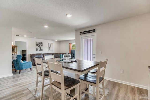 10885 Blacktail Loop, Pensacola, FL 32526 - dining area with light wood-style floors, baseboards, a textured ceiling, and recessed lighting