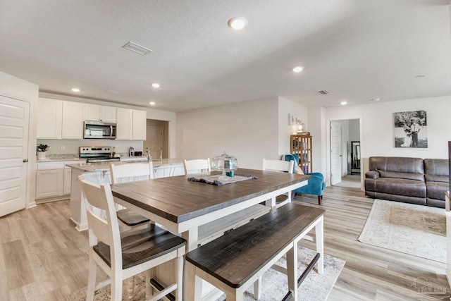 10885 Blacktail Loop, Pensacola, FL 32526 - dining space with light wood-style flooring and recessed lighting