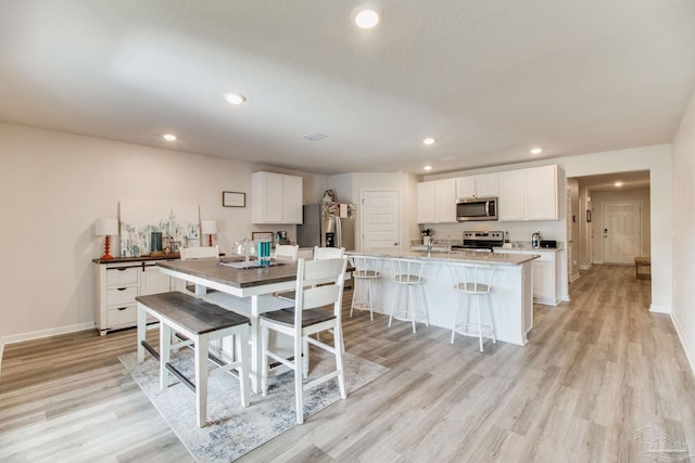 10885 Blacktail Loop, Pensacola, FL 32526 - dining room featuring light wood-type flooring, baseboards, and recessed lighting