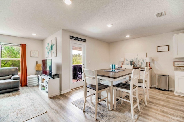 10885 Blacktail Loop, Pensacola, FL 32526 - dining room featuring light wood-type flooring, a textured ceiling, recessed lighting, and baseboards