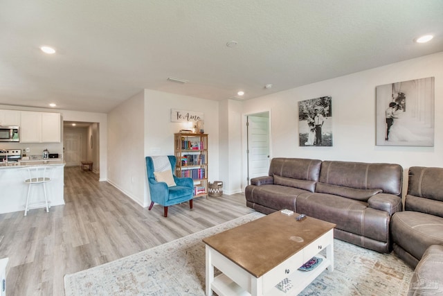 10885 Blacktail Loop, Pensacola, FL 32526 - living room featuring light wood-type flooring, baseboards, and recessed lighting