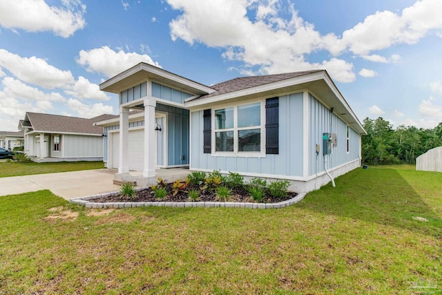 10885 Blacktail Loop, Pensacola, FL 32526 - view of front facade with board and batten siding, concrete driveway, a garage, a front yard, and roof with shingles