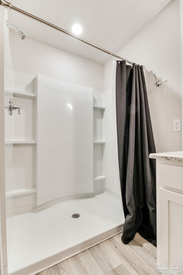 10885 Blacktail Loop, Pensacola, FL 32526 - bathroom with wood finished floors, a stall shower, and vanity