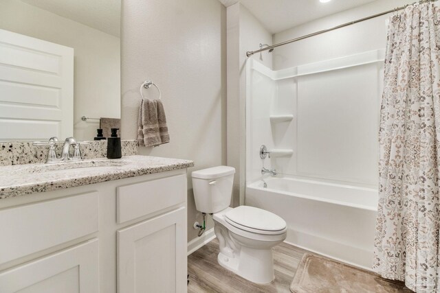 10885 Blacktail Loop, Pensacola, FL 32526 - bathroom with shower / bath combo with shower curtain, toilet, vanity, wood finished floors, and baseboards