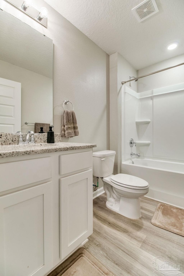 10885 Blacktail Loop, Pensacola, FL 32526 - full bath with toilet, wood finished floors, vanity, tub / shower combination, and a textured ceiling