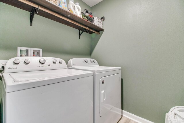 10885 Blacktail Loop, Pensacola, FL 32526 - laundry room with independent washer and dryer, baseboards, and light wood-style flooring