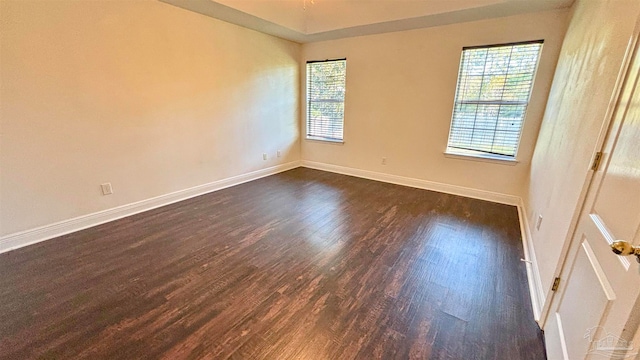 unfurnished room with dark hardwood / wood-style floors