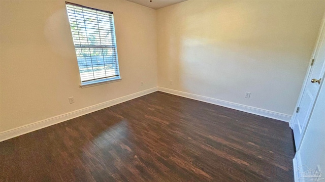 unfurnished room featuring dark hardwood / wood-style flooring and a healthy amount of sunlight