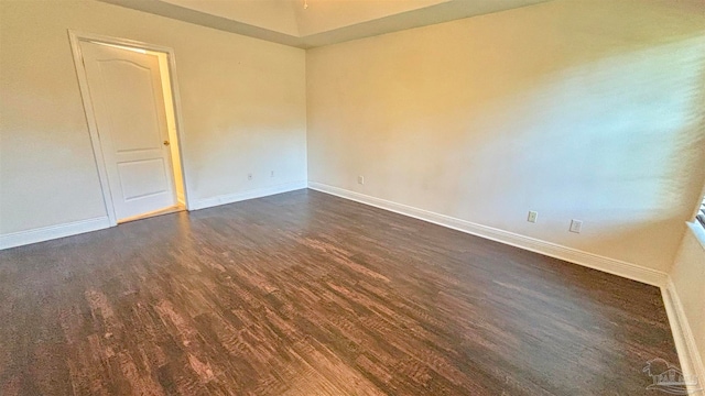 empty room featuring dark wood-type flooring