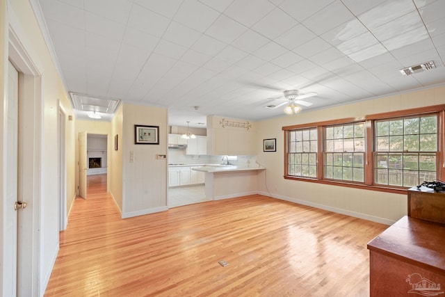 3570 Firestone Blvd, Pensacola, FL 32503 - unfurnished living room with attic access, a sink, light wood-style floors, ceiling fan, and visible vents