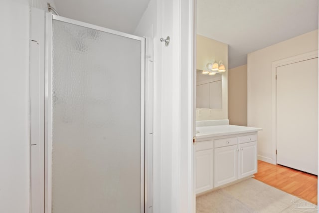 3570 Firestone Blvd, Pensacola, FL 32503 - full bath featuring wood finished floors, a stall shower, and vanity