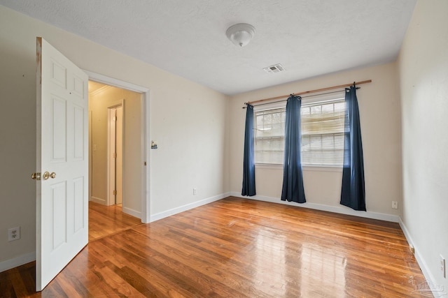 3570 Firestone Blvd, Pensacola, FL 32503 - empty room with baseboards, visible vents, wood finished floors, and a textured ceiling