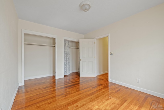 3570 Firestone Blvd, Pensacola, FL 32503 - unfurnished bedroom featuring light wood finished floors, baseboards, and two closets
