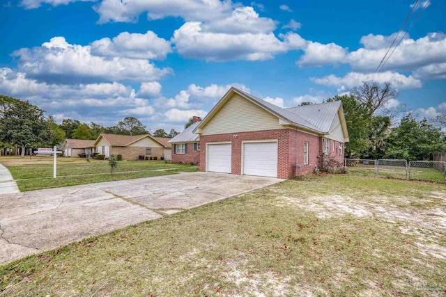 3570 Firestone Blvd, Pensacola, FL 32503 - view of front of property with driveway, fence, brick siding, a front lawn, and a garage