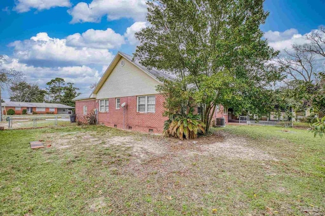 3570 Firestone Blvd, Pensacola, FL 32503 - view of property exterior featuring central air condition unit, fence, crawl space, brick siding, and a lawn