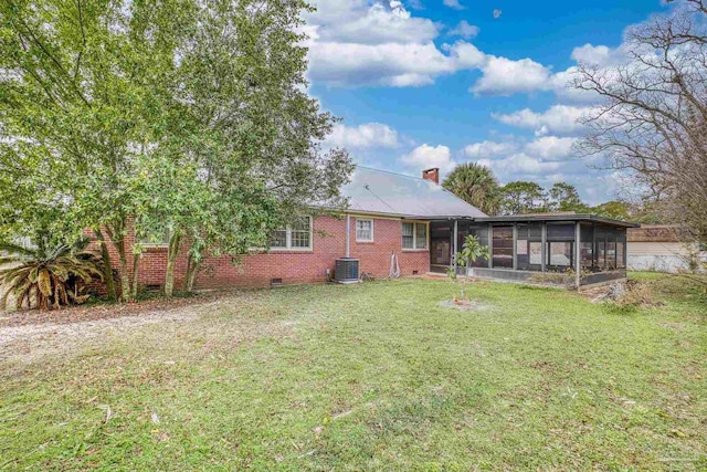 3570 Firestone Blvd, Pensacola, FL 32503 - rear view of house featuring crawl space, a chimney, a sunroom, a lawn, and central AC