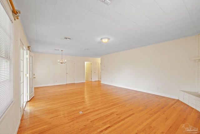 3570 Firestone Blvd, Pensacola, FL 32503 - unfurnished living room with baseboards, light wood-type flooring, visible vents, and an inviting chandelier