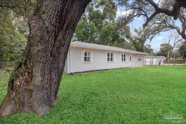 back of house with a lawn