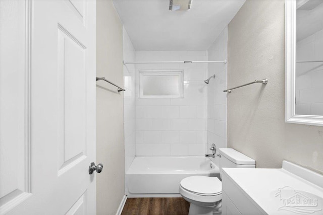 full bathroom featuring hardwood / wood-style flooring, vanity, toilet, and tiled shower / bath combo