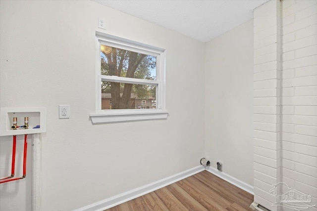 laundry room with washer hookup and hardwood / wood-style floors