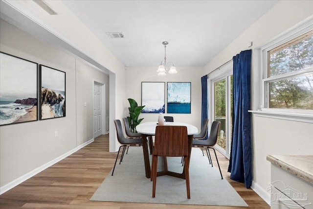 dining room with a notable chandelier and hardwood / wood-style floors