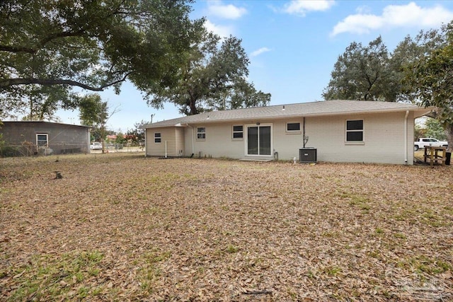 rear view of house featuring central AC