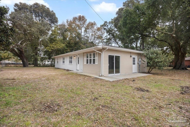 back of property featuring a yard and a patio area