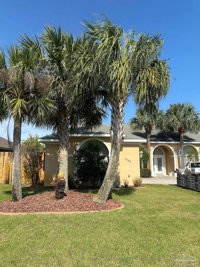 1988 Heritage Park Way, Navarre, FL 32566 - view of front of house with stucco siding and a front yard
