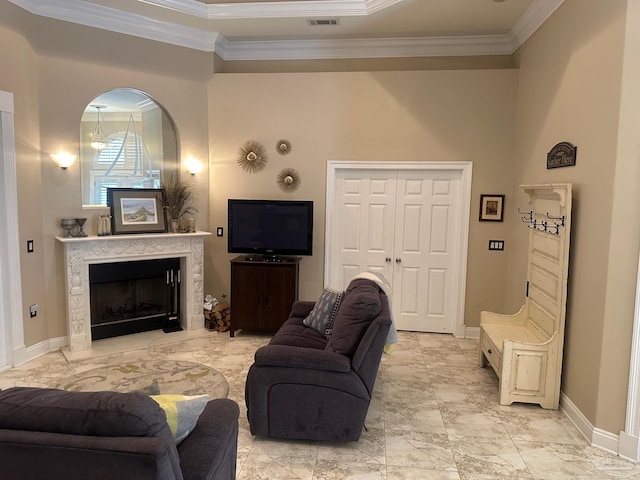 1988 Heritage Park Way, Navarre, FL 32566 - living room featuring crown molding, baseboards, a fireplace, and light marble finish floors